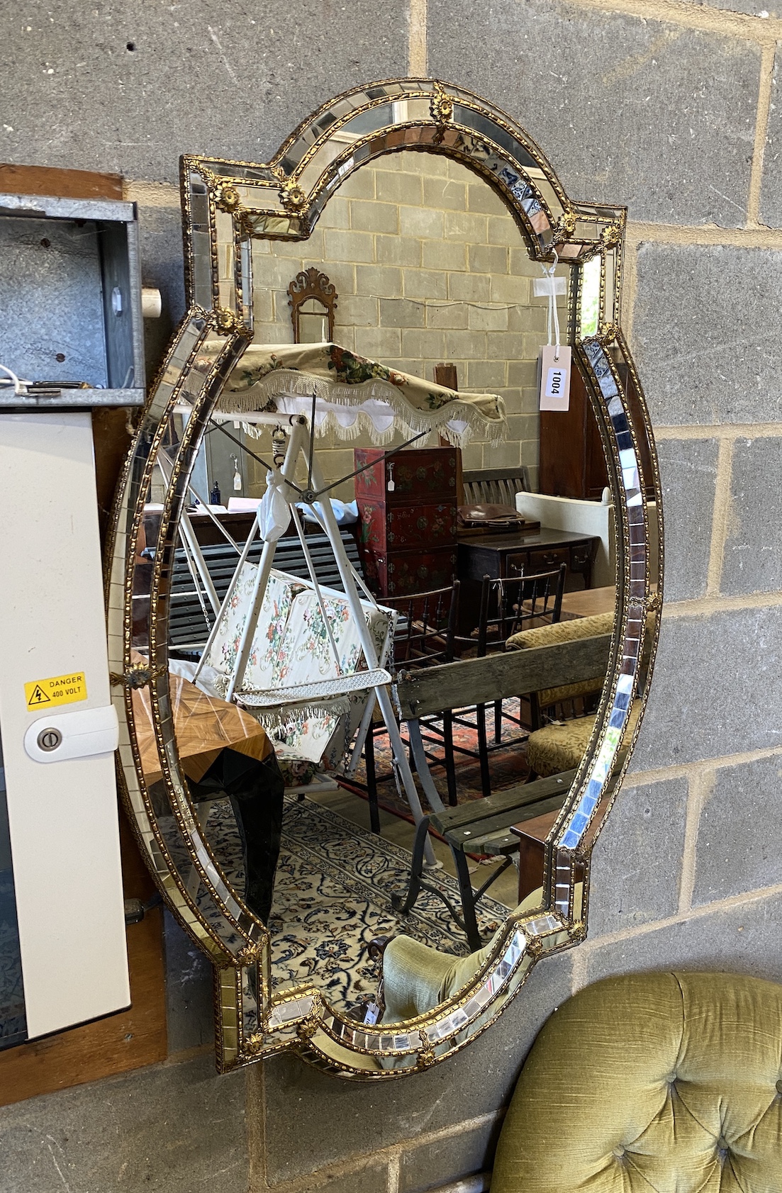 A Venetian style gilt metal oval wall mirror, width 71cm, height 111cm